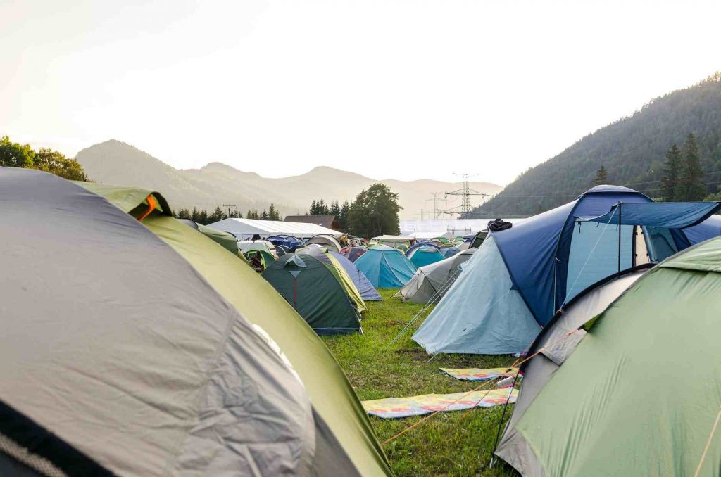 Many backpacking tents in a ground