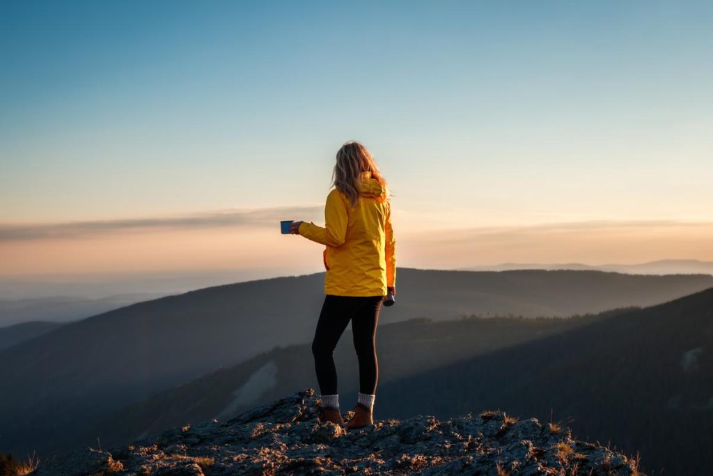 Women hiker wearing hiking jacket and telling you how to choose hiking jacket